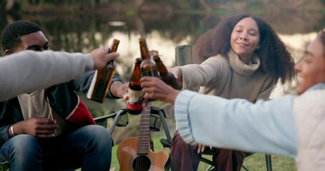 Camping, cheers and friends with alcohol in nature for holiday, vacation and adventure in woods. Friendship, party and men and women celebrate with drinks by bonfire for bonding, gathering and relax