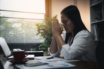 Businesswoman Praying with Eyes Closed. Businesswoman with her hands folded waiting for good news...