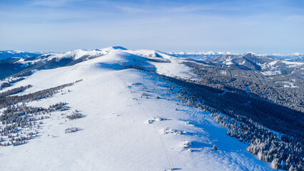 Fototapeta na wymiar Beautiful mountain range in winter with powder snow and blue sky