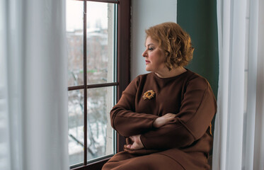 Sad Simple plump middle aged woman thinking about something, crisis of middle age and problems...