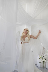 angel girl in a photo studio. White background .