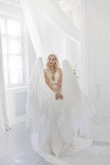 Fototapeta premium angel girl in a photo studio. White background .