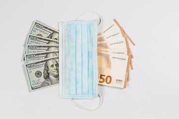 Medical mask and many banknotes of money, medical salary and economy