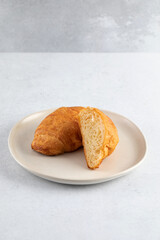 Fresh croissants on a grey background. French breakfast. 