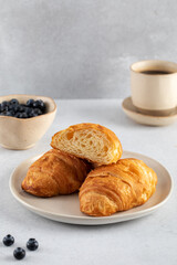 Fresh croissants on a plate. French breakfast.