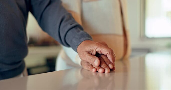 Closeup of couple, man and woman holding hands on table for love, care and trust together. Partner, loyalty and helping hand for kindness, sorry and commitment to support, hope and empathy to forgive
