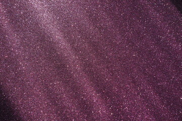 Oblique rays of light on a purple lilac surface. Bokeh, dust particles, reflection magical glow....