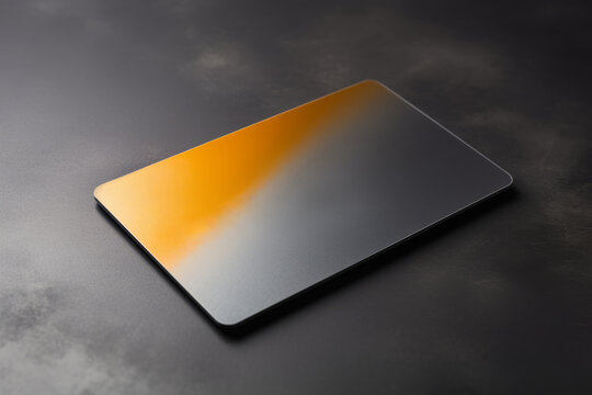 Blank credit card with microchip on grey background. Image of bank card painted yellow and grey on textured surface. Mockup for branding identity. Copy space.