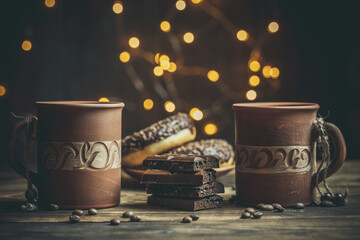 Beautiful mug with coffee and chocolate donuts on a beautiful background, holiday treats