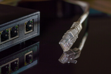 Close-up macro shot of a white RJ45 Ethernet cable on a black table with copy space