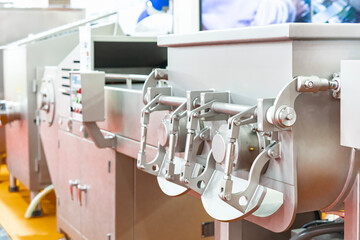 close up discharge gate of automatic commercial electric vacuum meat mixer machine in food industrial
