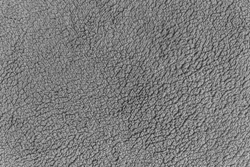abstract background grey plaid of artificial fur on a knitted basis close up