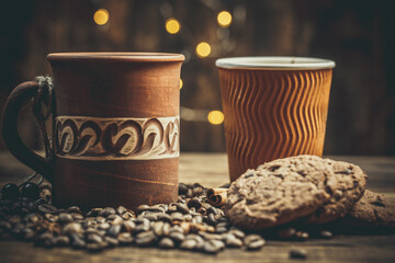 Beautiful mug with coffee and chocolate cookies on a beautiful background, holiday treats