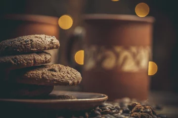 Tuinposter Beautiful mug with coffee and chocolate cookies on a beautiful background, holiday treats © Anton