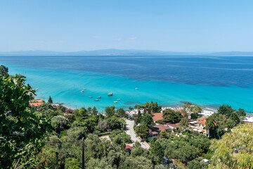 Afytos, Greece, July 17, 2023. Situated on top of a hill, the village of Afitos overlooks the Toronean Gulf, with a popular beach below.
