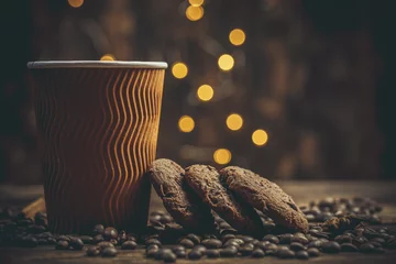 Keuken foto achterwand Koffiebar Paper cup with coffee and chocolate cookies on a beautiful background, holiday treats