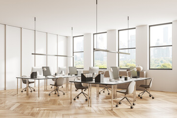 Stylish office workspace interior with pc computer and desk in row near window