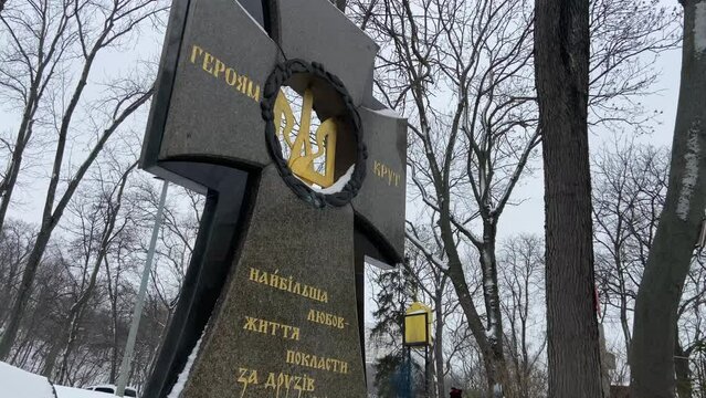 Askold's grave in Kyiv. Cross of memory of the heroes of Krut. The old necropolis. Askold mountain in winter. Inscription: To Heroes Krut. The greatest love of life is to give friends. 4k