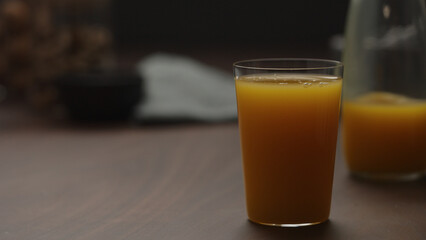 pumpkin juice in tumbler glass from wood table with copy space