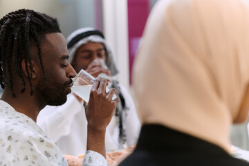 A traditional and diverse Muslim family comes together to share a delicious iftar meal during the sacred month of Ramadan, embodying the essence of familial joy, cultural richness, and spiritual unity
