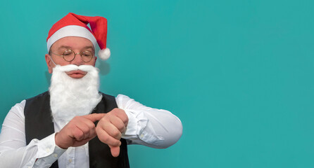 A man dresses up as Santa for a party. Deadline for christmas party. Copy space.