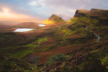 Epic sunrise or sunset view of the prehistoric Scottish Highlands landscape of the Cleat and the Quairaing from Trotternish Ridge on the Isle of Skye, Scotland.