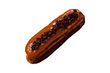 Delicious fresh eclair with chocolate cream on a black ceramic plate