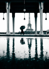 silhouette of tourist with umbrella walking at the Eiffel tower
