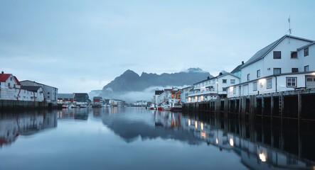 Fototapeta na wymiar cenic view of the waterfront harbor in Henningsvaer in summer. Henningsvaer is a fishing village and tourist town located on Austvagoya in the Lofoten Islands. Norway.