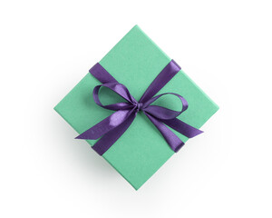 Top view of green gift box with purple ribbon bow isolated on white background