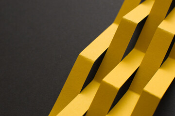 Black background with geometric yellow shapes, copy space