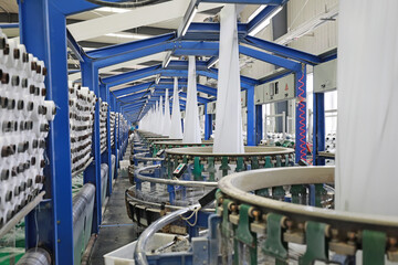 Workers working nervously on the fiber bag production line. - obrazy, fototapety, plakaty