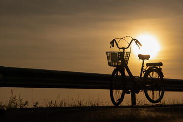 Bicycle on sunrise sky background