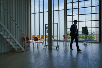 Seminar room with a businessman presenter walking from learning area.