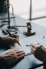 Justice and law concept.Male judge in a courtroom with the gavel, working with, computer and...