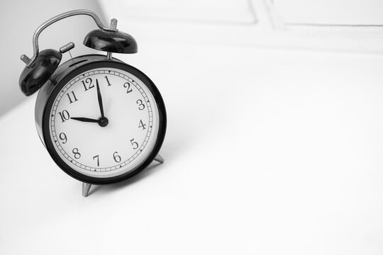 Black retro alarm clock on white background