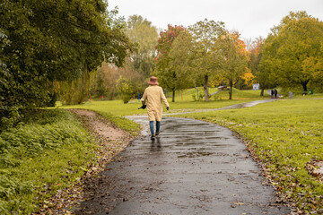 An adult man walking on the footpath in a public park in England