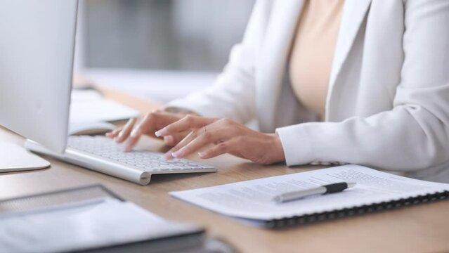 Woman sending emails, doing research and planning online for her startup business. Database administrator using software to store and organize data. Hands and fingers typing on computer keyboard.