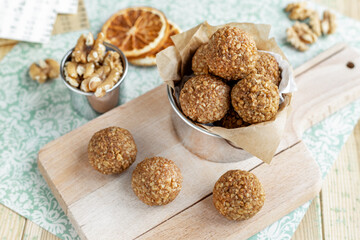 Caramelized walnut Bliss Balls, nut and orange sweets on board