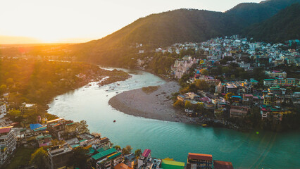 aerial view of the sacred city of Rishikesh and it important Ganges River at sunset - Uttarakhand,...