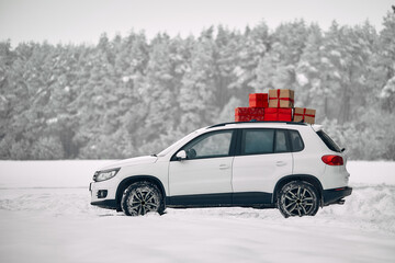 A car with gifts in winter. New Year's Eve and Christmas.
