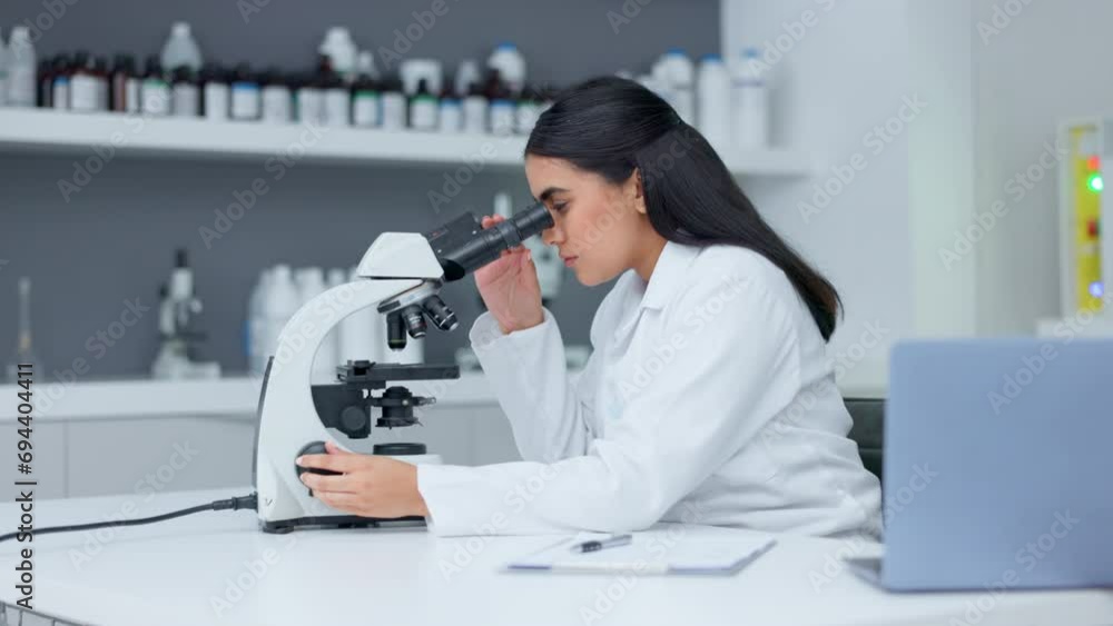 Aufkleber Laboratory scientist using a microscope to examine a virus. Biochemist engineer searching for breakthrough cure with medical research and writing discovery on clipboard with handheld camera motion
