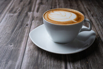 A Cappuccino coffee with balance of espresso, steamed milk and foam with shape of leaf