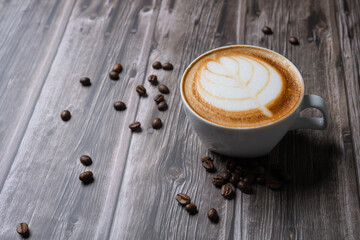 A Cappuccino coffee with balance of espresso, steamed milk and foam with shape of leaf