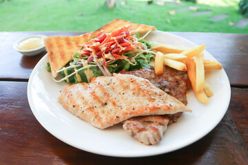 pork steak and chicken steak with French fries ,bread and salad or grilled pork and grilled chicken
