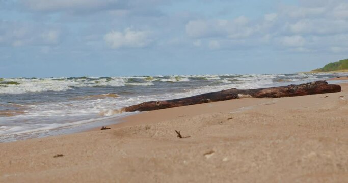 Ocean waves in autumn splendour: Low-angle view of sunny beach - serene coastal beauty in 4K