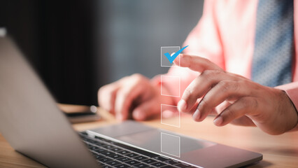 businessman using laptop doing online checklist survey, filling out digital form checklist, take an...