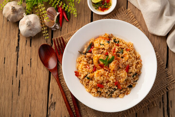 Spicy Shrimp and minced pork Fried Rice with thai holy basil leaves in white plate.Top view