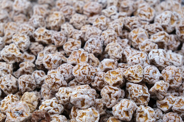 Li hing mui (huamei) full frame background. Salty dried Chinese plum snack food