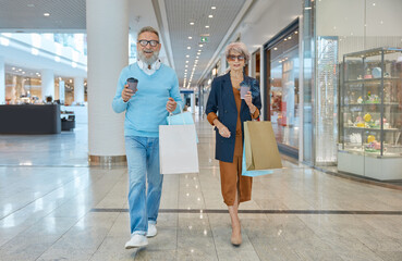 Fashionable elderly couple enjoying shopping tour on weekends - obrazy, fototapety, plakaty